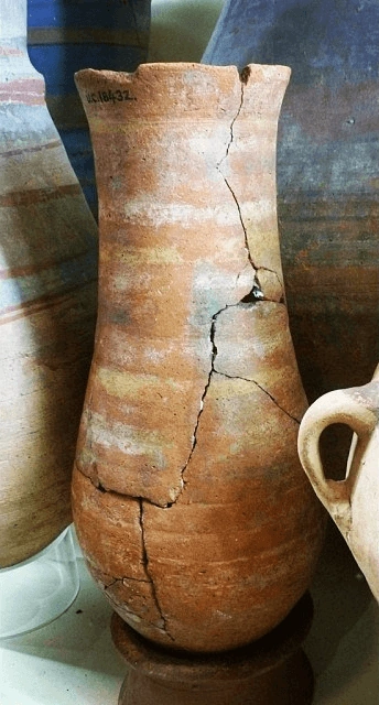 Redware pottery jar, painted white rings, broken and repaired. New Kingdom. 31.5 cm, UC18432 (Petrie Museum)