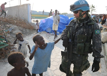 A Brazilian U.N. peacekeeper interacts with Haitian children while on patrol in Port-au-Prince in 2010. The peacekeepers were in Haiti to help in the wake of an earthquake earlier that year.