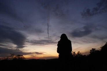 Photo of woman alone at dusk, by Joy Brown