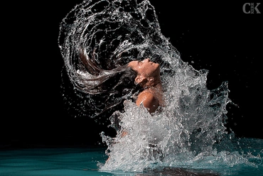 Photo of swimmer whipping water from her hair, by Caleb Kerr